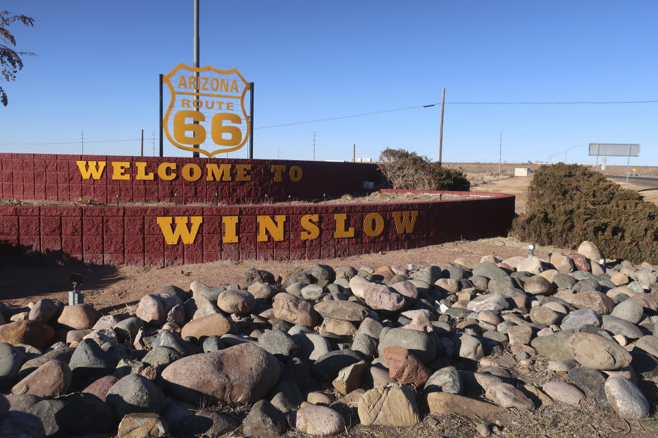 Signage along Route 66 welcomes visitors to Winslow, Arizona, in this photo taken Feb. 4, 2022. The U.S. Army Corps of Engineers recently announced a flood control project in the city would receive $65 million in funding. (AP Photo/Felicia Fonseca)
