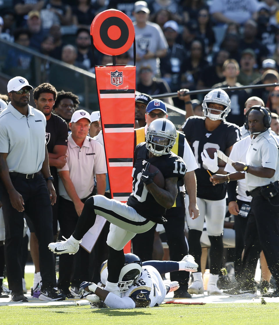 Los Angeles Rams' Keenen Brown (48) makes a tackle on Oakland Raiders' Rico Gafford (10) during the first half of a preseason NFL football game Saturday, Aug. 10, 2019, in Oakland, Calif. (AP Photo/Rich Pedroncelli)