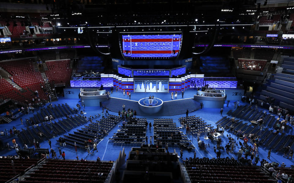 FILE - In this July 24, 2016, file photo, workers prepare for the Democratic National Convention in Philadelphia. Democratic presidential candidate former Vice Presiden JoBiden’s presidential nominating convention will highlight the U.S. political spectrum from the left flank of New York Rep. Alexandria Ocasio-Cortez to the Republican old guard of former Ohio Gov. John Kasich. But that doesn’t mean there’s room for every prominent Democrat who would get a share of the spotlight at a routine convention taking place without the backdrop of a pandemic.(AP Photo/Paul Sancya, File)