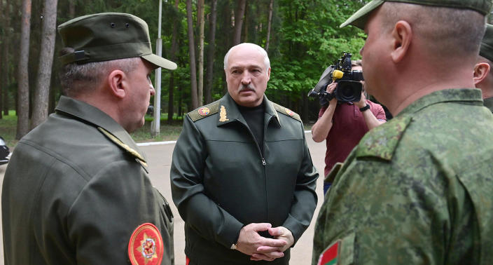 In this handout photo released by Belarus' Presidential Press Office, Belarusian President Alexander Lukashenko, center, speaks to officers as he visits the Central Command Post of the Air Force and Air Defense Forces in Belarus, Monday, May 15, 2023. (Belarus' Presidential Press Office via AP)