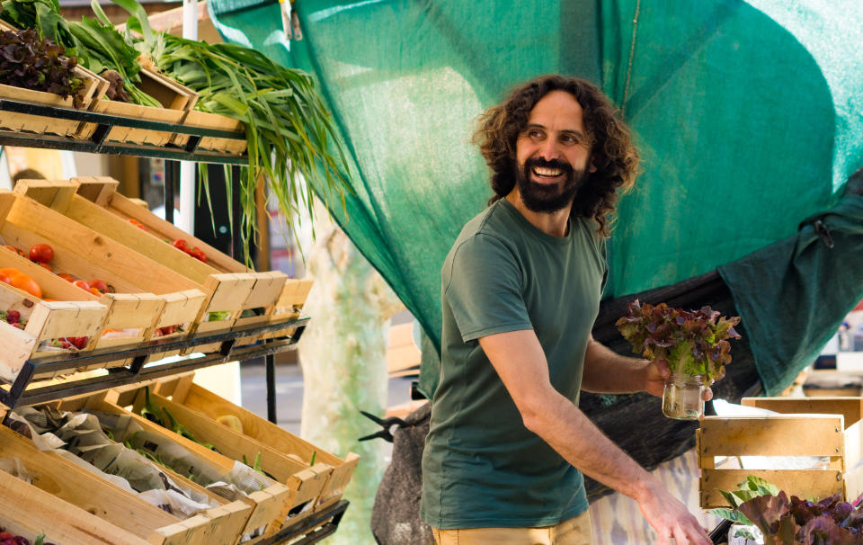 A person smiling at a local market