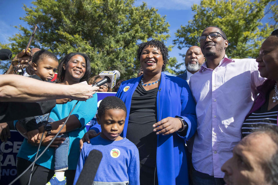 Surrounded by family and supporters, Georgia gubernatorial candidate Stacey Abrams speaks with the press after casting her early ballot at The Gallery at South DeKalb Mall in Decatur, Monday, October 22, 2018. Today marks only 15 days left until Election Day on Tuesday, November 6. (Alyssa Pointer/Atlanta Journal-Constitution via AP)