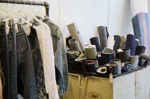 Rolls of selvedge denim next to a rack of ready-to-purchase 3x1 pieces. Photo: Whitney Bauck/Fashionista