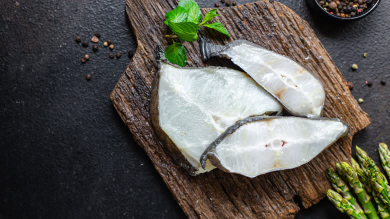 catfish steaks on wooden cutting board