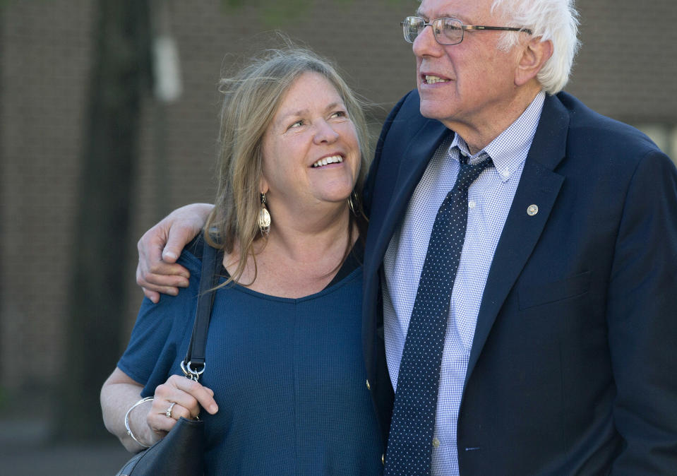 FILE - In this April 19, 2016, file photo, Democratic presidential candidate Sen. Bernie Sanders, I-Vt., and his wife Jane take a walk in State College, Pa. The Sanders Institute, a think tank founded by Democratic presidential contender Bernie Sanders’ wife and son, has stopped accepting donations and plans to suspend all operations by the end of May. (AP Photo/Mary Altaffer, File)