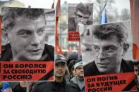 Russian opposition supporters carry pictures of murdered opposition leader Boris Nemtsov during a march in central Moscow on March 1, 2015