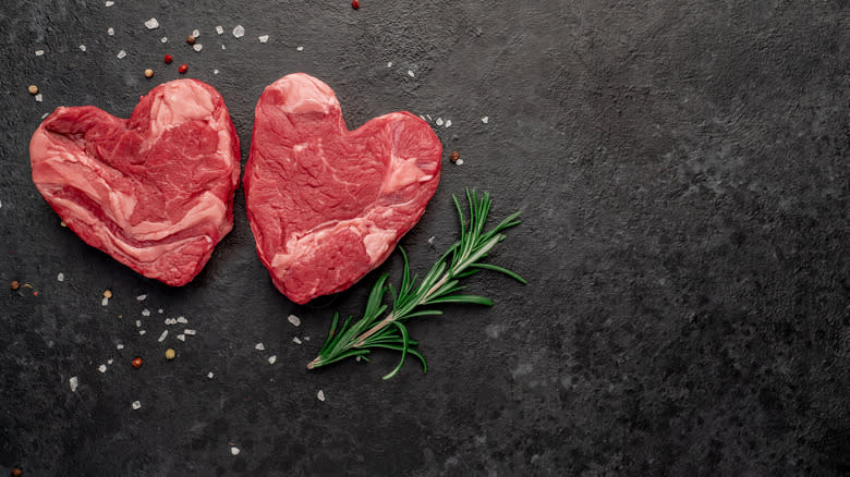 raw steaks in heart shape