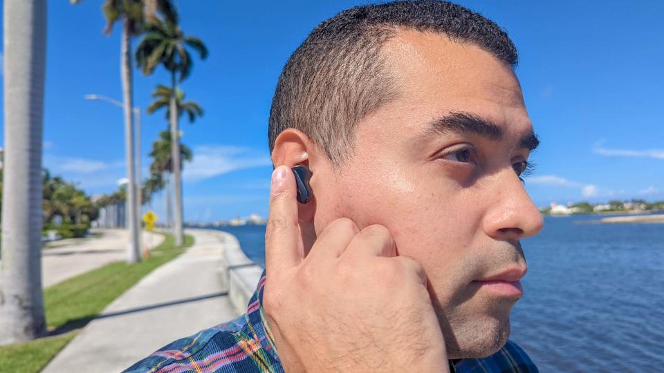 Bose QuietComfort Earbuds 2 worn by reviewer using touch controls