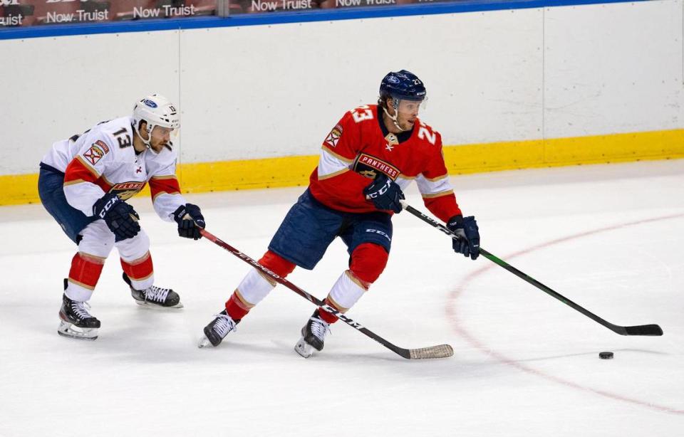 Florida Panthers center Carter Verhaeghe (23) carries the puck against Panthers center Vinnie Hinostroza (13) during the first period of the first training camp scrimmage in preparation for the 2021 NHL season at the BB&T Center on Thursday, January 7, 2021 in Sunrise.