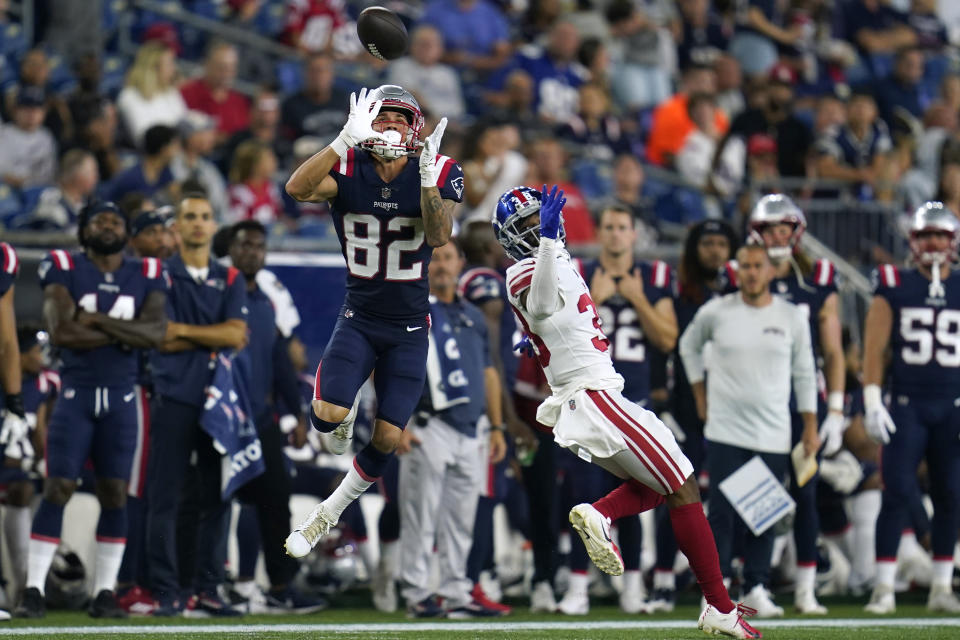 New England Patriots wide receiver Tre Nixon (82) makes a catch as New York Giants cornerback Zyon Gilbert (38) defends during the second half of a preseason NFL football game Thursday, Aug. 11, 2022, in Foxborough, Mass. (AP Photo/Charles Krupa)