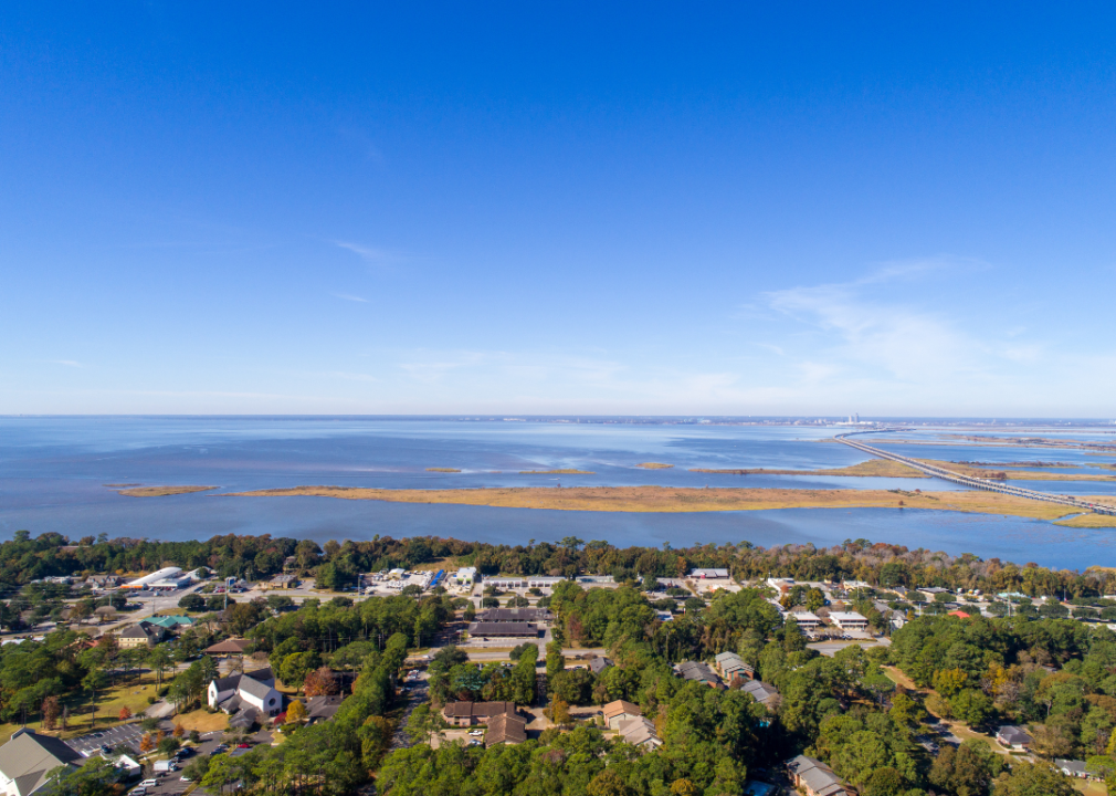 Aerial view of a city by the body of water.