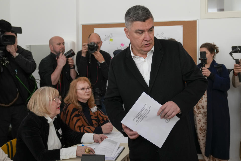 Croatia's President Zoran Milanovic holds his ballot at a polling station in Zagreb, Croatia, Wednesday, April 17, 2024. Croatia is voting in a parliamentary election after a campaign that centred on a bitter rivalry between the president and prime minister of the small European Union and NATO member. (AP Photo/Darko Bandic)