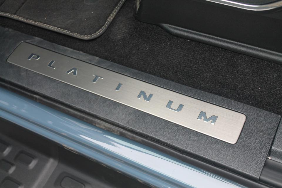 The door sill of the 2023 Ford F-150 Lightning Platinum, with the word "PLATINUM" on a metal background.