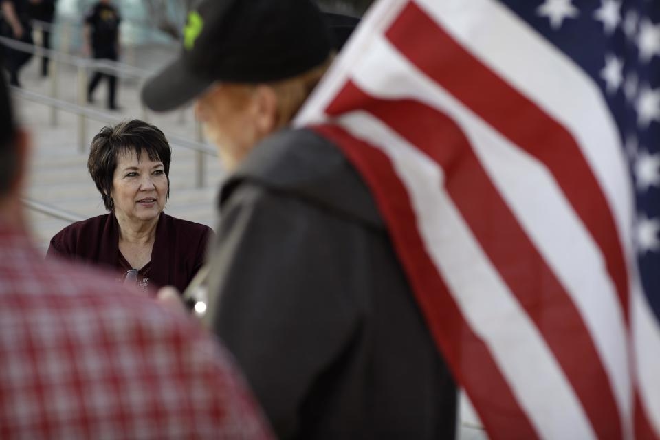 Carol Bundy, left, wife of Nevada rancher Cliven Bundy, speaks with supporters outside of the federal courthouse, Thursday, Feb. 9, 2017, in Las Vegas. A jury begins to decide Thursday in Las Vegas if six men who wielded weapons to block a federal round-up of cattleman Cliven Bundy's cows in 2014 were citizens exercising constitutional free speech and weapon rights or armed insurrectionists who conspired against the government. (AP Photo/John Locher)