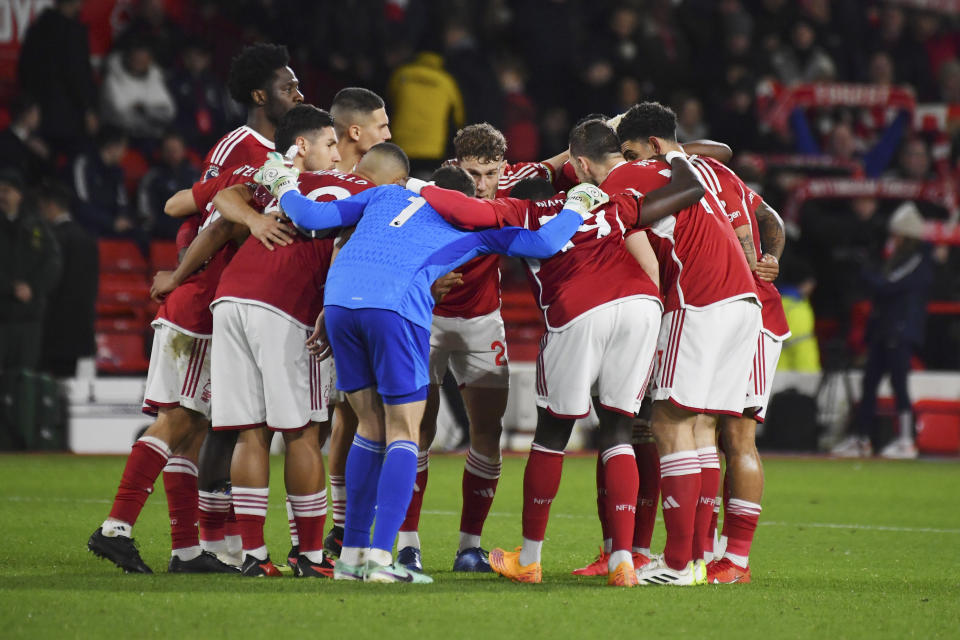 Nottingham Forest's team players hug before the second half of the English Premier League soccer match between Nottingham Forest and Manchester United at City Ground in Nottingham, England, Saturday, Dec. 30, 2023. (AP Photo/Rui Vieira)