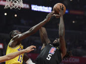 Los Angeles Clippers forward Montrezl Harrell, right, shoots as Los Angeles Lakers guard Isaac Bonga defends during the first half of an NBA basketball game Friday, April 5, 2019, in Los Angeles. (AP Photo/Mark J. Terrill)