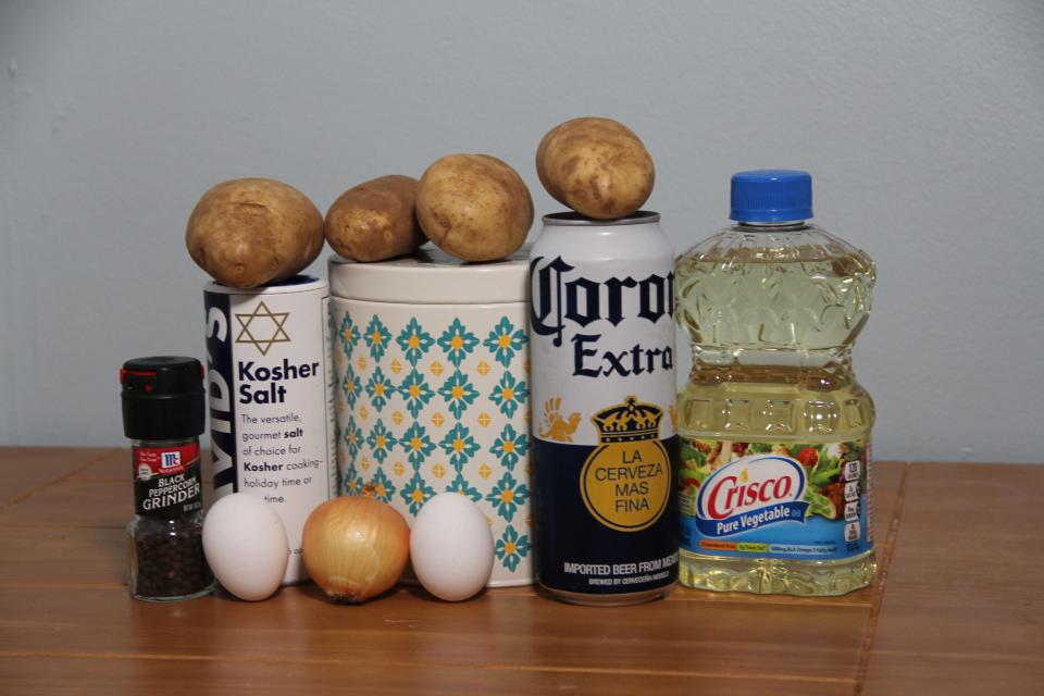 The ingredients for Martha Stewart's latkes: potatoes, eggs, onion, beer, oil, salt, and pepper.