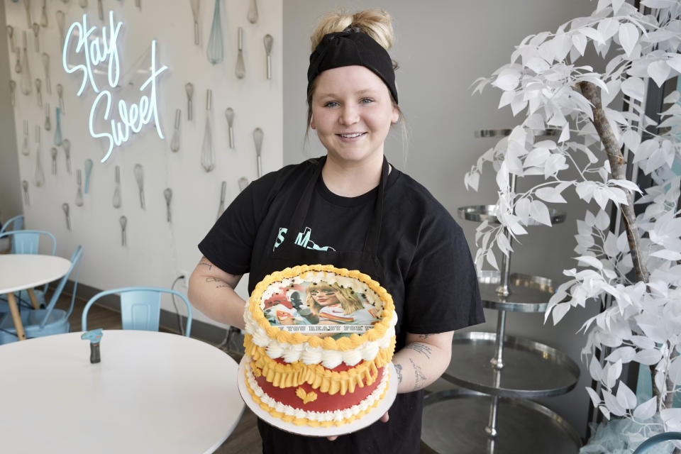 Maddie Schmitz, owner of Something Sweet by Maddie Lu, displays one of her "burn away cakes" in Coon Rapids, Minn., Monday, Feb. 5, 2024. Schmitz created the Taylor Swift/Travis Kelce cakes just in time for NFL football's upcoming Super Bowl. (AP Photo/Mark Vancleave)