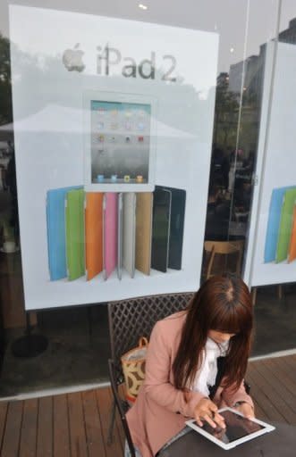 A South Korean customer uses an Apple iPad 2 at a branch of KT, a Korean partner for iPhones and iPads at downtown Seoul in 2011. Google, Apple, Microsoft and Yahoo! are all in the struggle for mobile Web dominance, along with the Norwegian-made Opera browser and the open source Firefox software from Mozilla