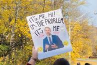 <p>A protester holds a sign with a photo of Ontario Minister of Education Stephen Lecce, along with the lyrics, "It's me, hi! I'm the problem, it's me," from Taylor Swift's hit song, "Anti-Hero." (Photo via @parentaction4ed on Twitter)</p> 