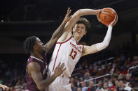 Southern California guard Drew Peterson (13) looks to pass while defended by Eastern Kentucky guard Russhard Cruickshank during the first half of an NCAA college basketball game Tuesday, Dec. 7, 2021, in Los Angeles. (AP Photo/Ringo H.W. Chiu)