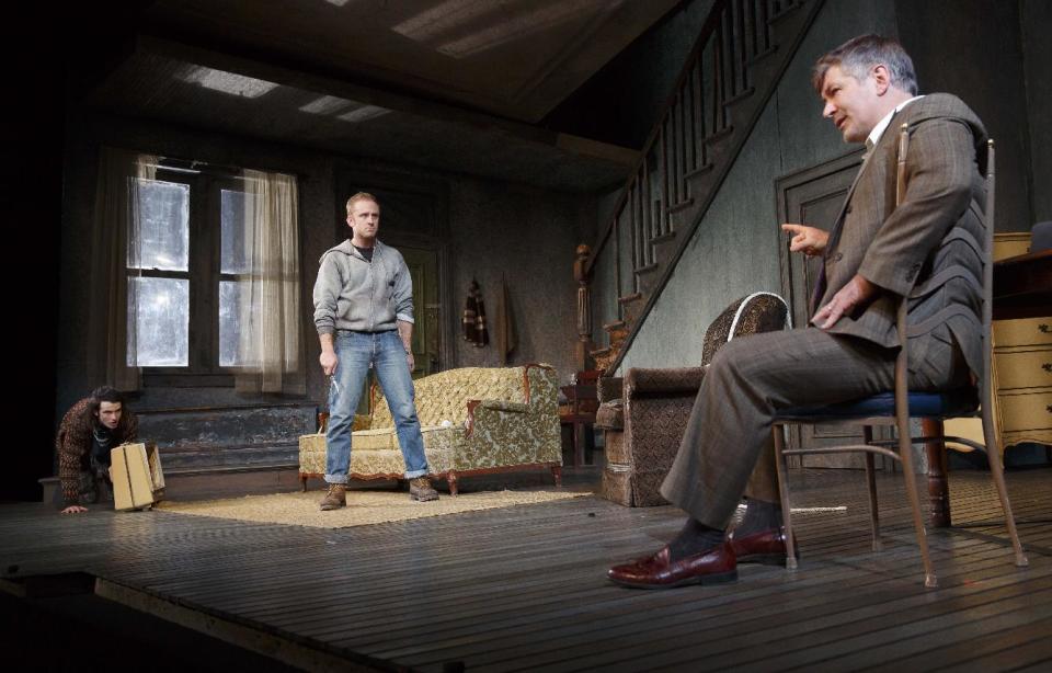 This theater image released by Boneau/Bryan-Brown shows, from left, Tom Sturridge, Ben Foster and Alec Baldwin during a performance of "Orphans," at the Gerald Schoenfeld Theatre in New York. (AP Photo/Boneau/Bryan-Brown, Joan Marcus)