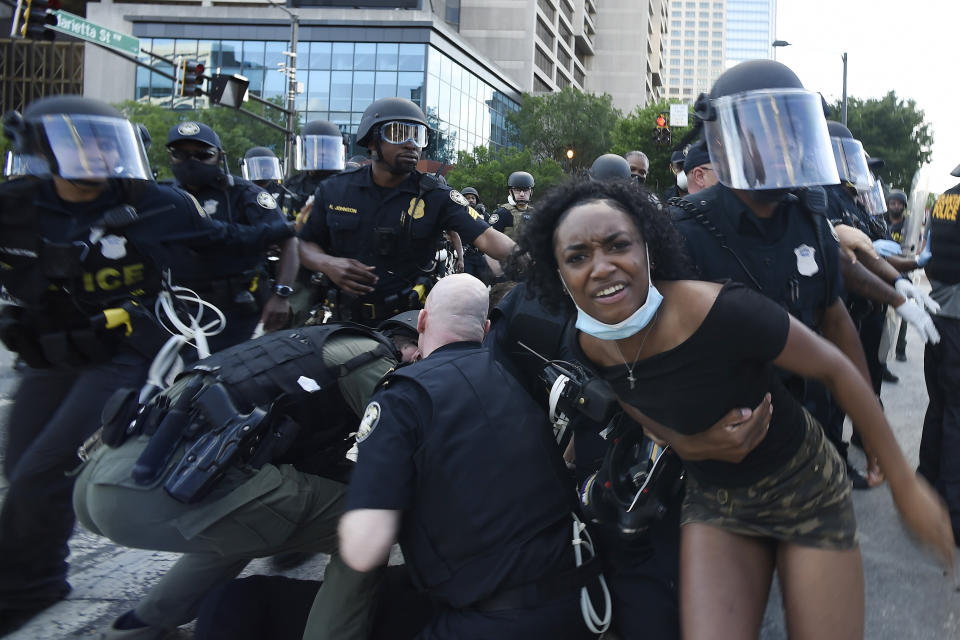 Police detain demonstrators protesting in Atlanta on Saturday. The protest started peacefully earlier in the day before demonstrators clashed with police. (Photo: ASSOCIATED PRESS)