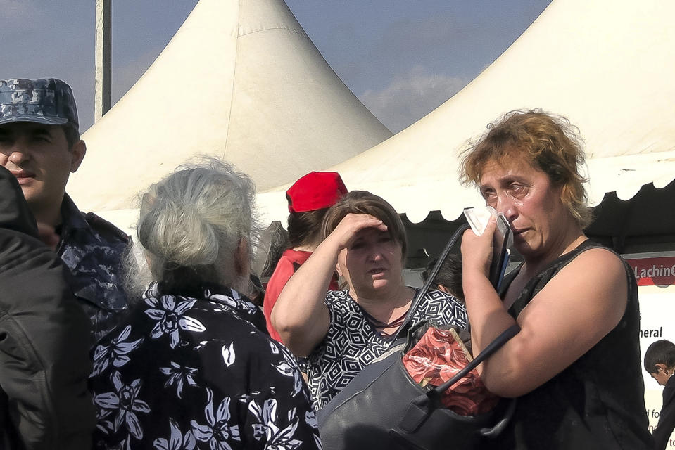 In this image taken from video, refugees from the first group of about 30 people from Nagorno-Karabakh gather in a temporary camp after arriving to Armenia's Kornidzor village in Syunik region, Armenia, Sunday, Sept. 24, 2023. The first refugees from Nagorno-Karabakh have arrived in Armenia, local officials reported Sunday, and more were expected to come after a 10-month blockade and a lightning military offensive this month that resulted in Azerbaijan reclaiming full control of the breakaway region. (AP Photo)