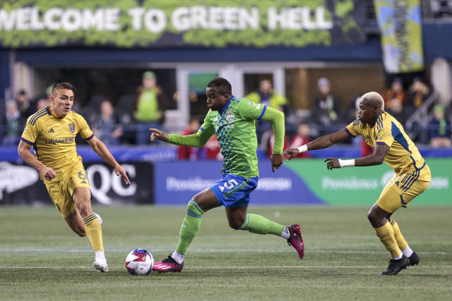 Seattle Sounders defender Nouhou Tolo (5) moves the ball as Real Salt Lake midfielder Braian Ojeda (6) and forward Carlos Andres Gomez defend during the second half of an MLS soccer match Saturday, March 4, 2023, in Seattle. The Sounders won 2-0. (AP Photo/Jason Redmond)