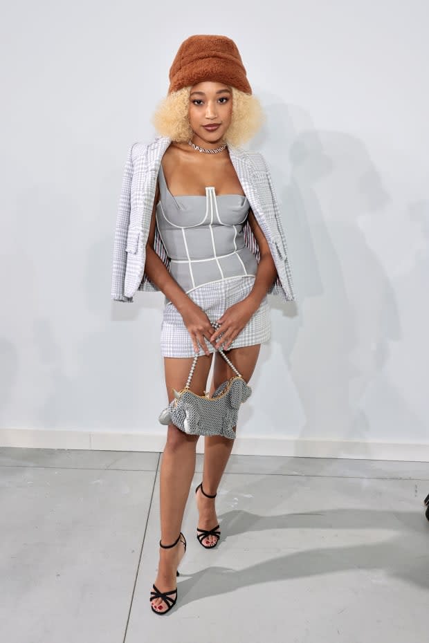 Amandla Stenberg at Thom Brown's Fall 2022 show, wearing a corset with a checked mini skirt suit from the brand.<p>Photo: Jamie McCarthy/Getty Images</p>