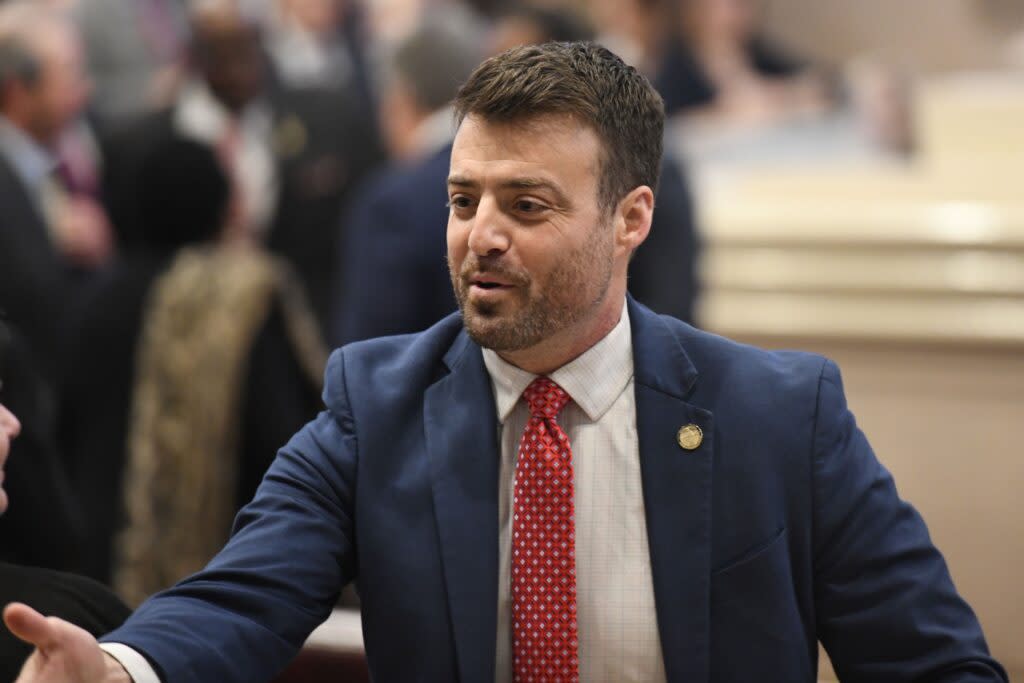 A man in a blue suit and red tie