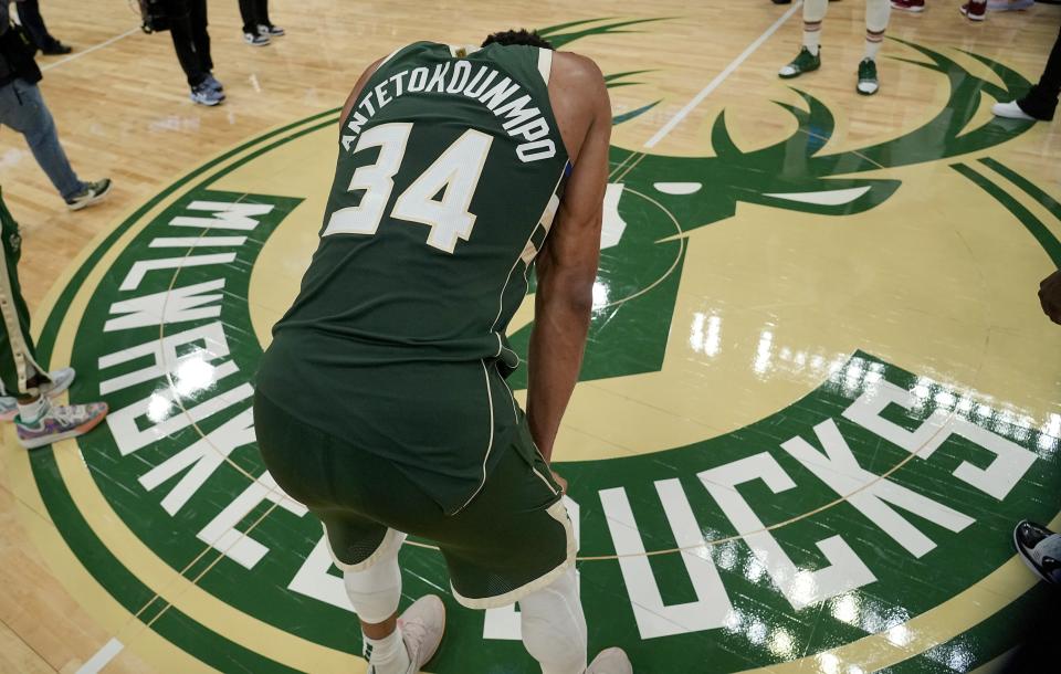 Giannis Antetokounmpo hangs his head at center court after the Bucks were eliminated from the NBA playoffs Wednesday night with a 128-126 overtime loss to the Heat.