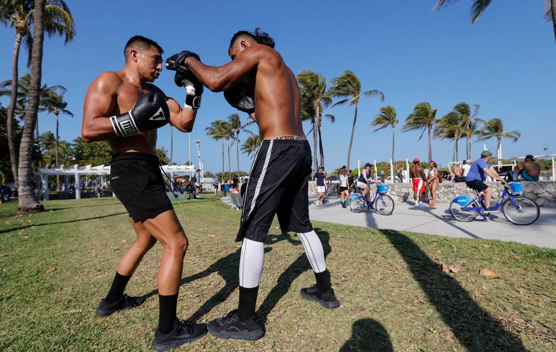 Leo Carrera, 35, and Paulo Arenas, 27, of Miami, spar across from the Art Deco Hotels along Ocean Drive during spring break on Miami Beach, Florida on Sunday, March 17, 2024.