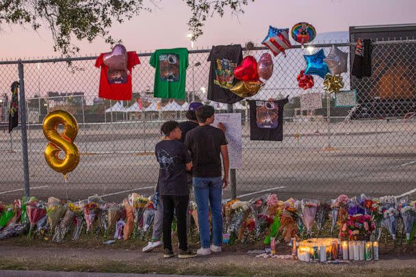 PHOTO: In this Nov. 7, 2021, file photo, local high school students who attended the Travis Scott concert sign a remembrance board at a makeshift memorial at the NRG Park grounds in Houston, Texas. (Thomas Shea/AFP via Getty Images, FILE)