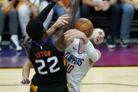 Los Angeles Clippers center Ivica Zubac, right, is fouled by Phoenix Suns center Deandre Ayton (22) during the second half of Game 1 of the NBA basketball Western Conference finals Sunday, June 20, 2021, in Phoenix. (AP Photo/Ross D. Franklin)