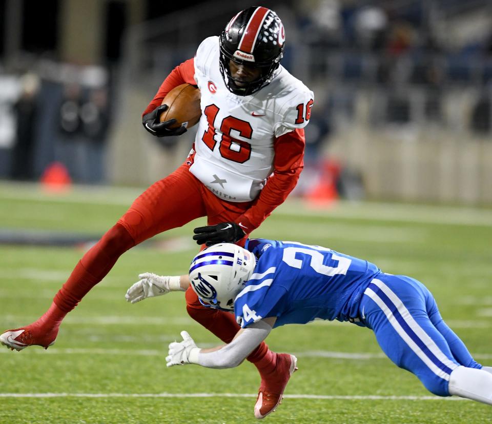 Wyoming's Joel Hancock tries to stop Glenville quarterback Deonte Rucker in first half play against Wyoming Cowboys in the OHSAA Division IV State Championship football game at Tom Benson Hall of Fame Stadium. Saturday, December 03, 2022. 