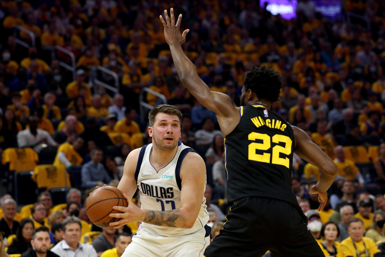 Andrew Wiggins (right) playing defense against Luka Doncic (left).