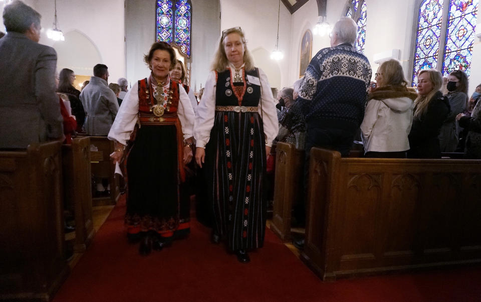 Jeannette Henrikssen, president of the church council, right and Queen Sonja of Norway walk out of Den Norske Lutherske Mindekirke, the Norwegian Lutheran Memorial Church in Minneapolis, Sunday Oct. 16, 2022. (AP Photo/Giovanna Dell'Orto)