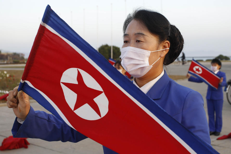 Wearing face masks members of Women's Union in Wonsan city make agitation activities to encourage workers during the rush hour in front of Haean Plaza in the city of Wonsan, Kangwon Province, North Korea DPRK, on Wednesday, Oct., 28, 2020. (AP Photo/Jon Chol Jin)