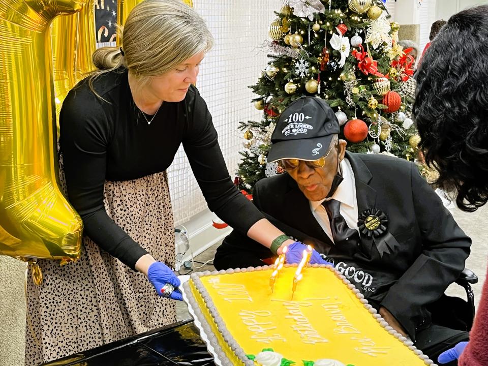 Rev. Brown blows out the candles on his birthday cake.
