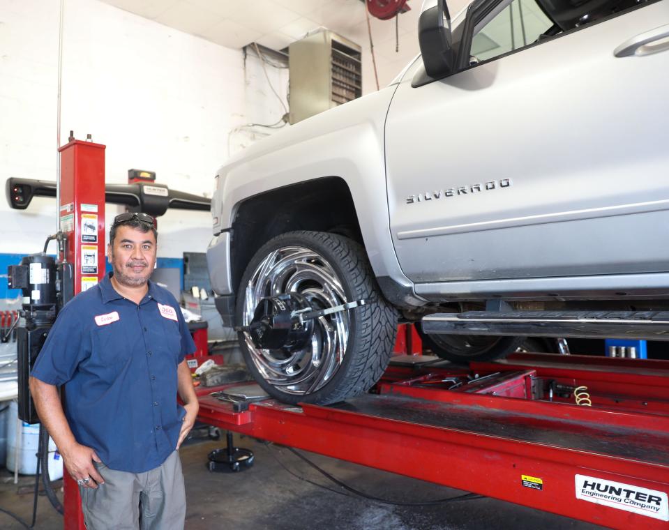 Carlos Villalpando, owner of 360 Wheel Repair, stands next to a truck in need of repair on Monday, Oct. 3, 2022 at 360 Wheel Repair in Memphis.