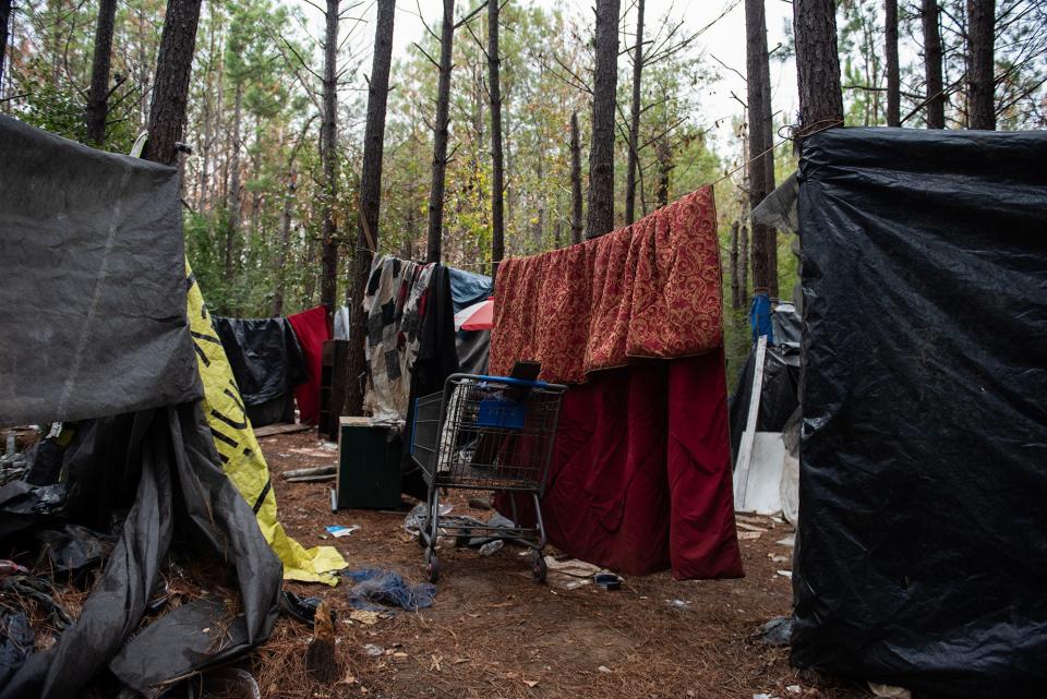 A group of homeless people live in an encampment in a wooded area of Southwest Jackson, Miss., seen on Friday, Nov. 17, 2023.