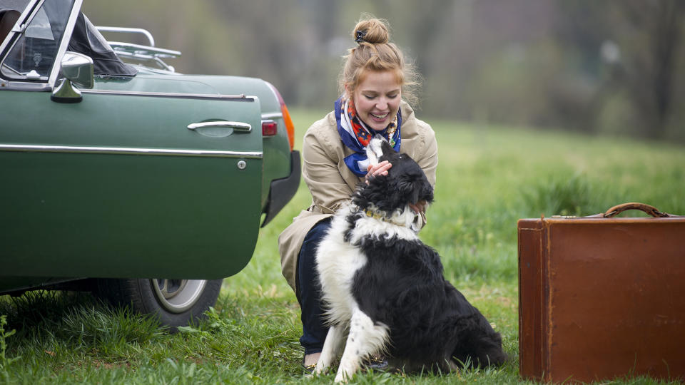 Woman saying goodbye to dog