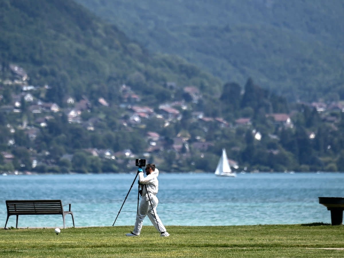 A French forensic police officer during the investigation around the lake (Olivier Chassignole/AFP via Getty Images)