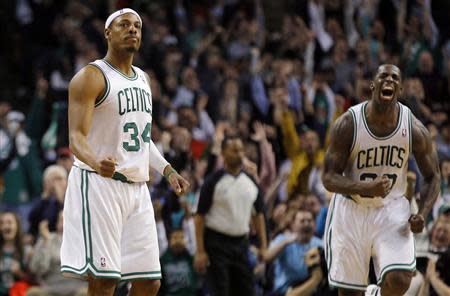 Boston Celtics forwards Paul Pierce (L) and Brandon Bass react after a Celtics basket in the final minutes of their NBA basketball game against the Chicago Bulls in Boston, Massachusetts February 13, 2013. REUTERS/Brian Snyder