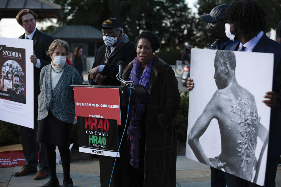 Rep. Sheila Jackson Lee speaks at a press conference, showing a black-and-white photograph of a Black man seen from behind, with horrific scarification on his back.