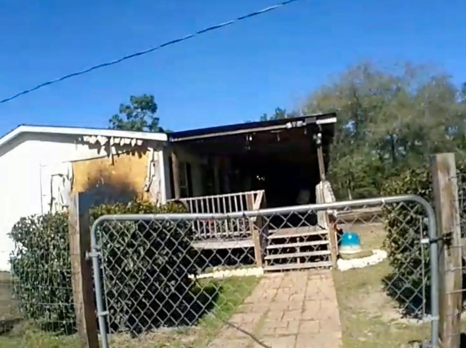 A Walton County sheriff's deputy's body camera footage shows a home in Mossy Head that was damaged by a fire Sunday. A postal worker sprang into action and called 911 after spotting the fire outside the home.