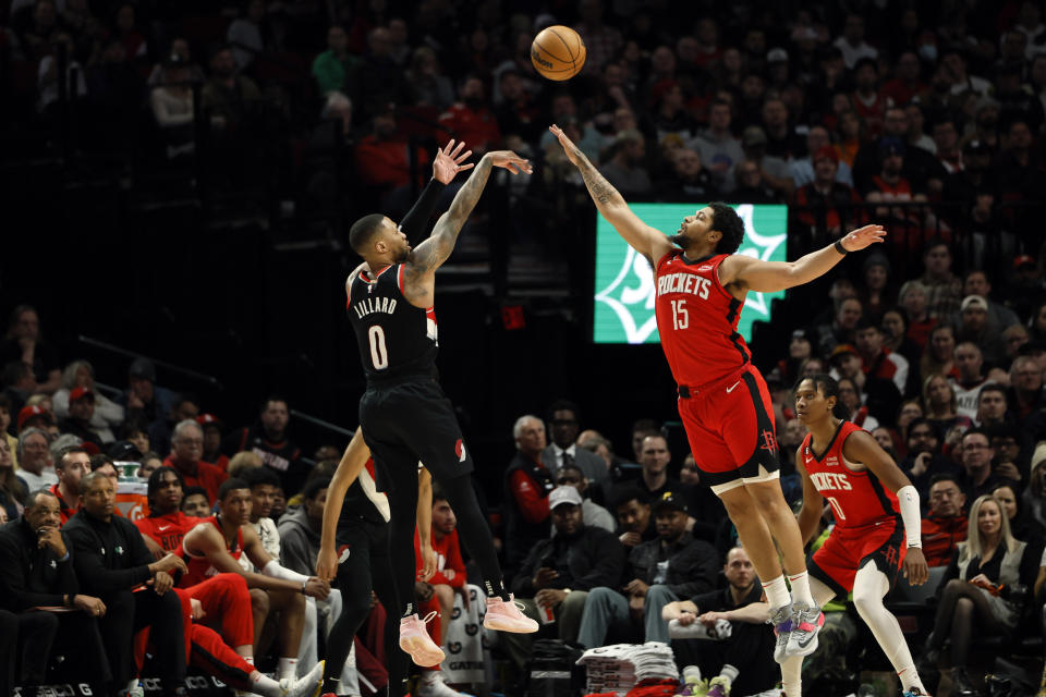 Feb 26, 2023; Portland, Oregon, USA; Portland Trail Blazers point guard Damian Lillard (0) shoots the ball over Houston Rockets shooting guard Daishen Nix (15) during the second half at Moda Center. Mandatory Credit: Soobum Im-USA TODAY Sports