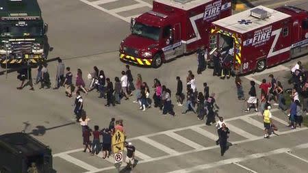 Students are evacuated from Marjory Stoneman Douglas High School during a shooting incident in Parkland, Florida, U.S. February 14, 2018 in a still image from video. WSVN.com via REUTERS.