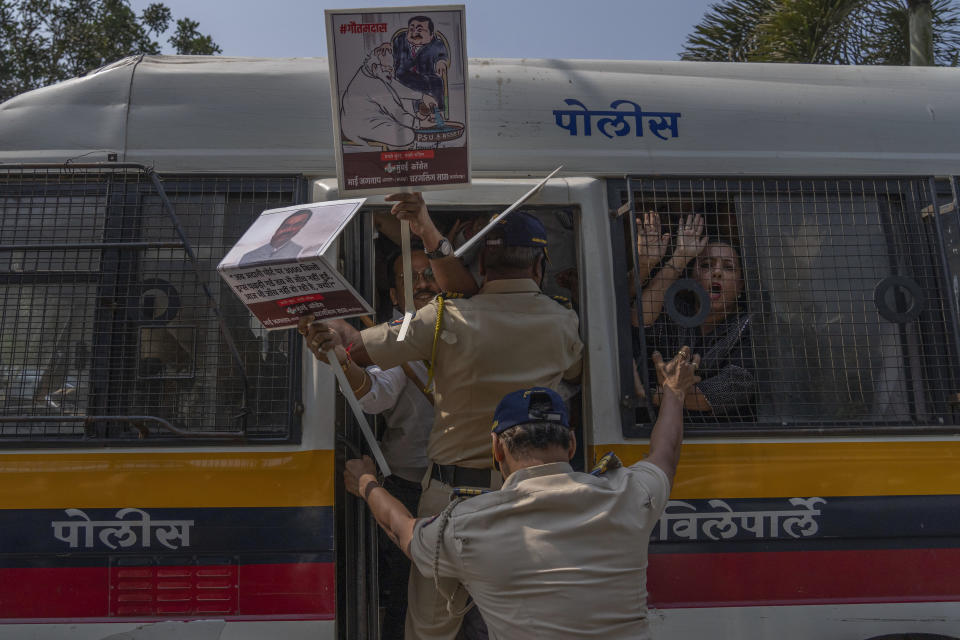 Members of opposition Congress party shout slogans inside a police vehicle as they were detained during a protest demanding an investigation into allegations of fraud and stock manipulation by India's Adani Group outside National Stock Exchange in Mumbai, India, Wednesday, March 1, 2023. The Adani Group suffered a massive sell-off of its shares after a U.S.-based short-selling firm, Hindenburg Research, accused it of various fraudulent practices. The Adani Group has denied any wrongdoing. (AP Photo/Rafiq Maqbool)